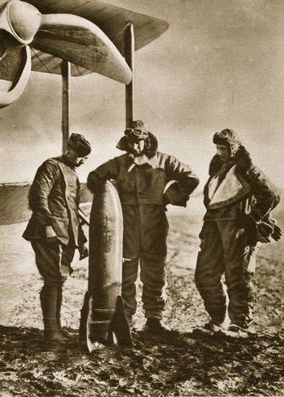 The Sowers: British airmen contemplating a bomb which will scatter death among the foe by English Photographer